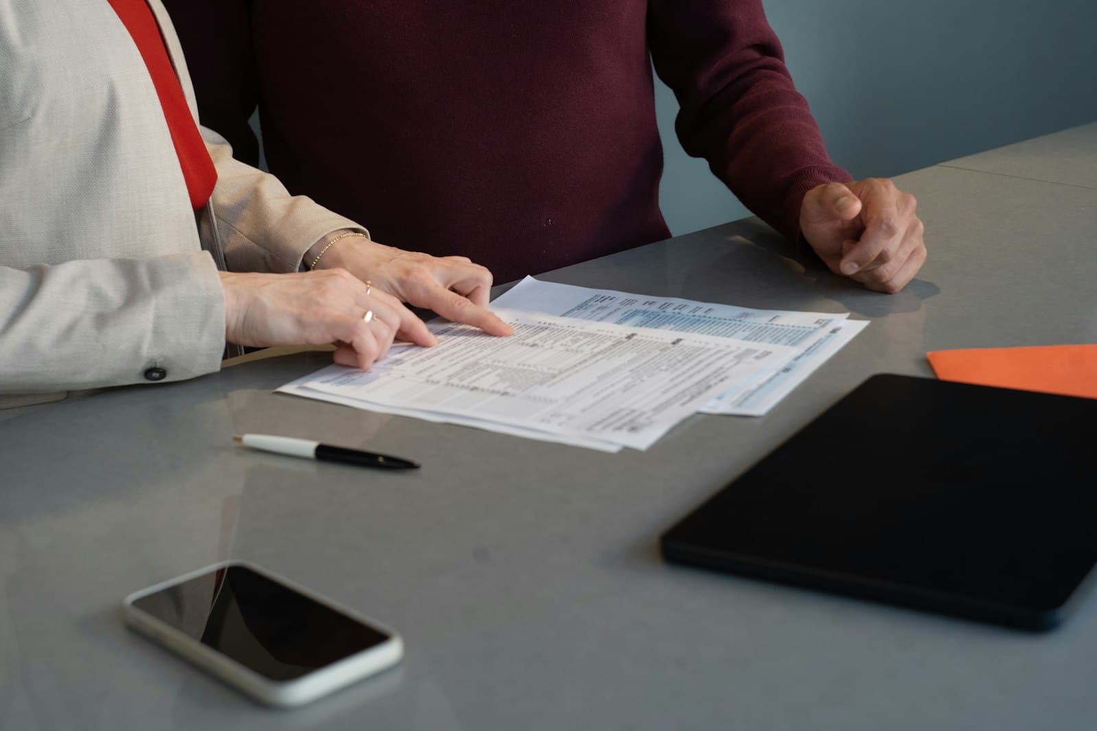 Two people reviewing documents together at a table.