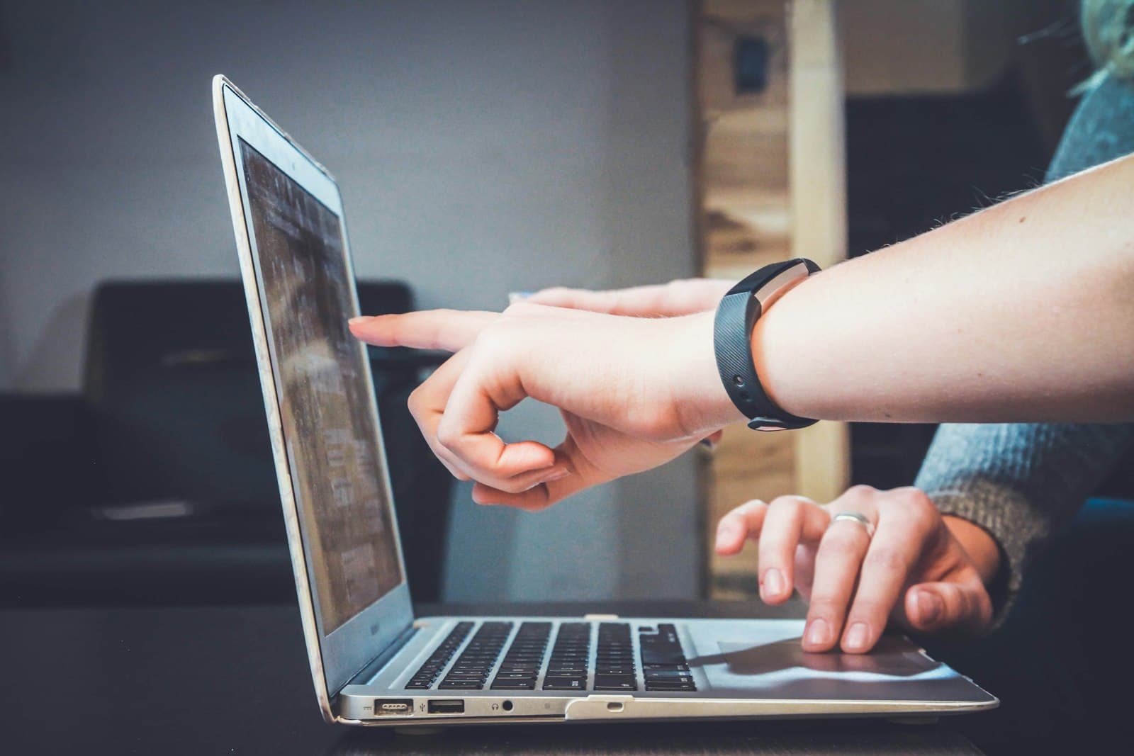 A person using a laptop for shared document work.